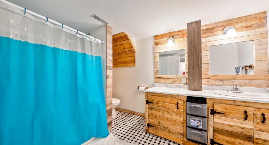Full bathroom adds convenience and functionality to the lower level.