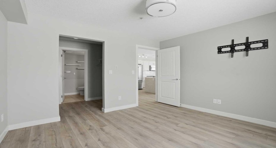 Primary bedroom, looking towards walk-through closet and ensuite