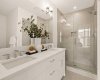 Primary ensuite with dual sinks and walk-in tiled shower.