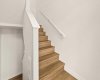 Stairs to lower level storage and double attached garage.
