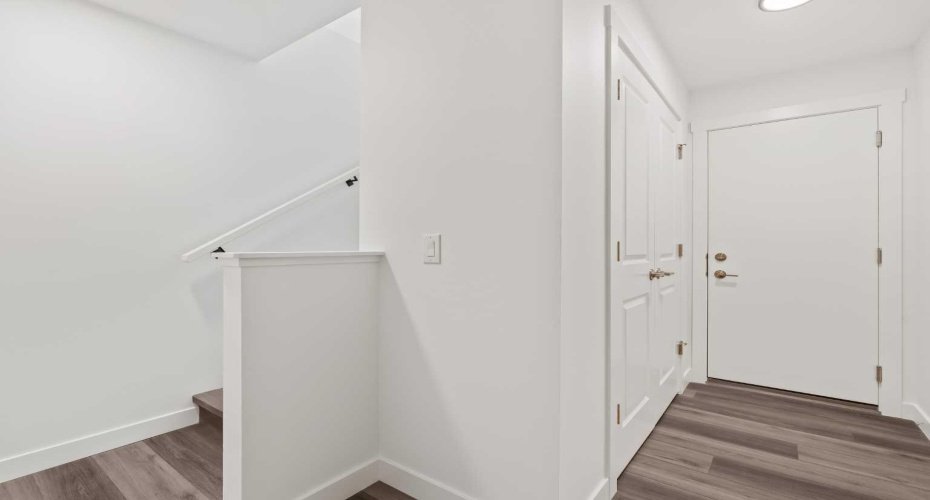 Basement hallway with double closet and access to lower level utility/storage/hobby room.