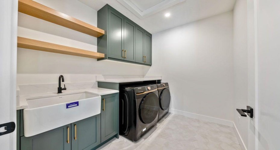 Laundry room with custom shelving and quartz counter