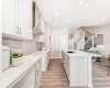 Kitchen view to Pantry & Stairs to Upper Floor • PLEASE NOTE: Photos are of a DIFFERENT Spec Home of the same model – fit and finish may differ. Interior selections and floorplans shown in photos. Kitchen appliances are included, and will be installed prior to possession.