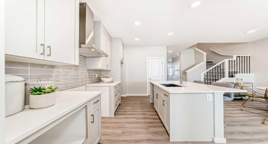 Kitchen view to Pantry & Stairs to Upper Floor • PLEASE NOTE: Photos are of a DIFFERENT Spec Home of the same model – fit and finish may differ. Interior selections and floorplans shown in photos. Kitchen appliances are included, and will be installed prior to possession.