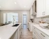 Kitchen view to Rear Entry/Mudroom • PLEASE NOTE: Photos are of a DIFFERENT Spec Home of the same model – fit and finish may differ. Interior selections and floorplans shown in photos. Kitchen appliances are included, and will be installed prior to possession.