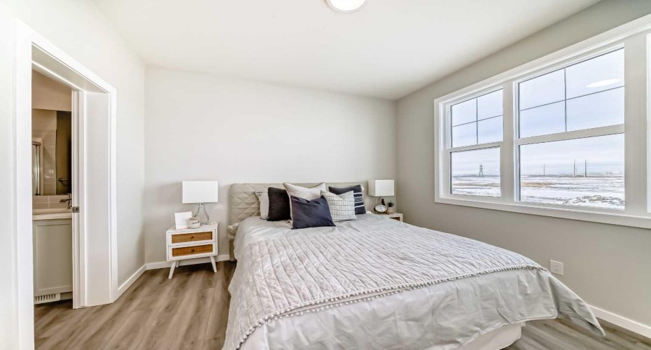 Main Floor Bedroom • PLEASE NOTE: Photos are of a DIFFERENT Spec Home of the same model – fit and finish may differ. Interior selections and floorplans shown in photos.