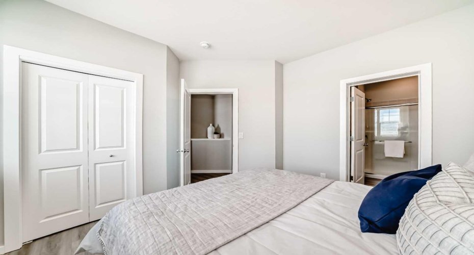 Main Floor Bedroom • PLEASE NOTE: Photos are of a DIFFERENT Spec Home of the same model – fit and finish may differ. Interior selections and floorplans shown in photos.