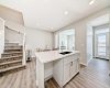 Stairs to Upper Floor • PLEASE NOTE: Photos are of a DIFFERENT Spec Home of the same model – fit and finish may differ. Interior selections and floorplans shown in photos. Kitchen appliances are included, and will be installed prior to possession.