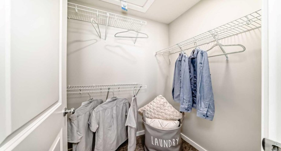 Master Walk-in Closet • PLEASE NOTE: Photos are of a DIFFERENT Spec Home of the same model – fit and finish may differ. Interior selections and floorplans shown in photos.
