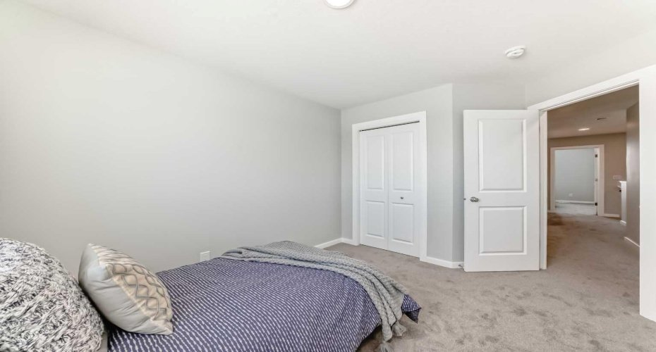Upper Floor Bedroom Two • PLEASE NOTE: Photos are of a DIFFERENT Spec Home of the same model – fit and finish may differ. Interior selections and floorplans shown in photos.