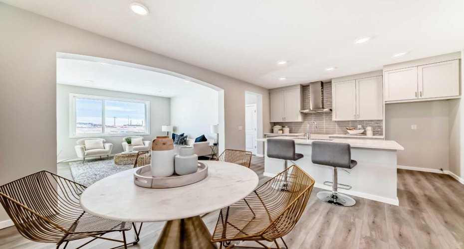 Dining Area & Kitchen • PLEASE NOTE: Photos are of a DIFFERENT Spec Home of the same model – fit and finish may differ. Interior selections and floorplans shown in photos. Kitchen appliances are included, and will be installed prior to possession.
