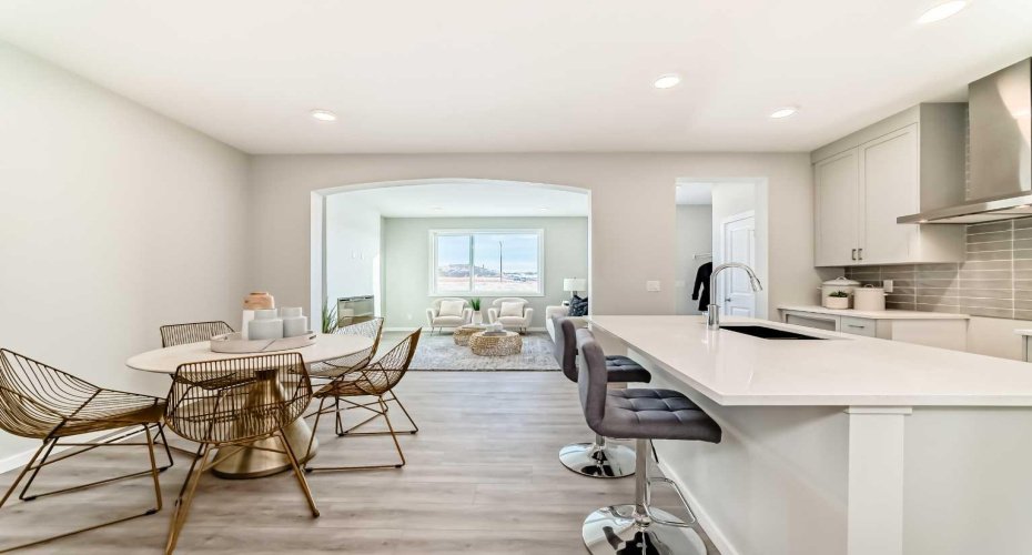Kitchen & Dining Area view to Living Room • PLEASE NOTE: Photos are of a DIFFERENT Spec Home of the same model – fit and finish may differ. Interior selections and floorplans shown in photos. Kitchen appliances are included, and will be installed prior to possession.