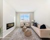 Living Room with Fireplace Feature Wall • PLEASE NOTE: Photos are of a DIFFERENT Spec Home of the same model – fit and finish may differ. Interior selections and floorplans shown in photos.