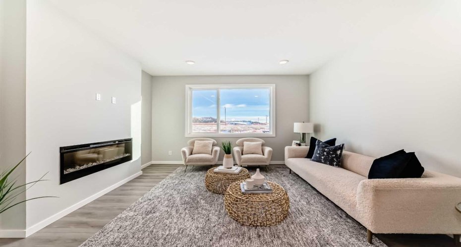 Living Room with Fireplace Feature Wall • PLEASE NOTE: Photos are of a DIFFERENT Spec Home of the same model – fit and finish may differ. Interior selections and floorplans shown in photos.
