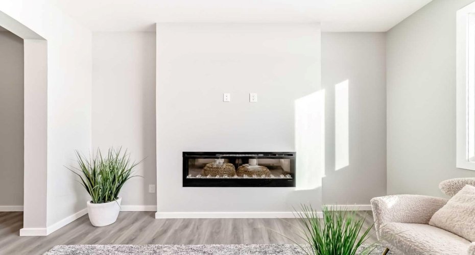 Living Room with Fireplace Feature Wall • PLEASE NOTE: Photos are of a DIFFERENT Spec Home of the same model – fit and finish may differ. Interior selections and floorplans shown in photos.