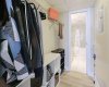 Walk-through closet with hanging bars on both sides and room for additional storage units.