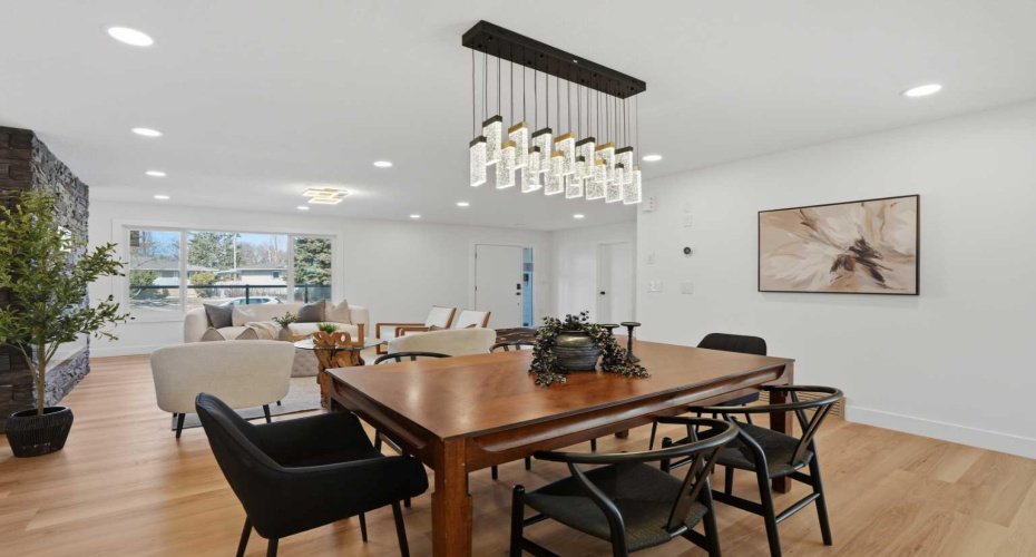 Elegant dining area featuring a statement chandelier, and seamless connection to the bright living space.