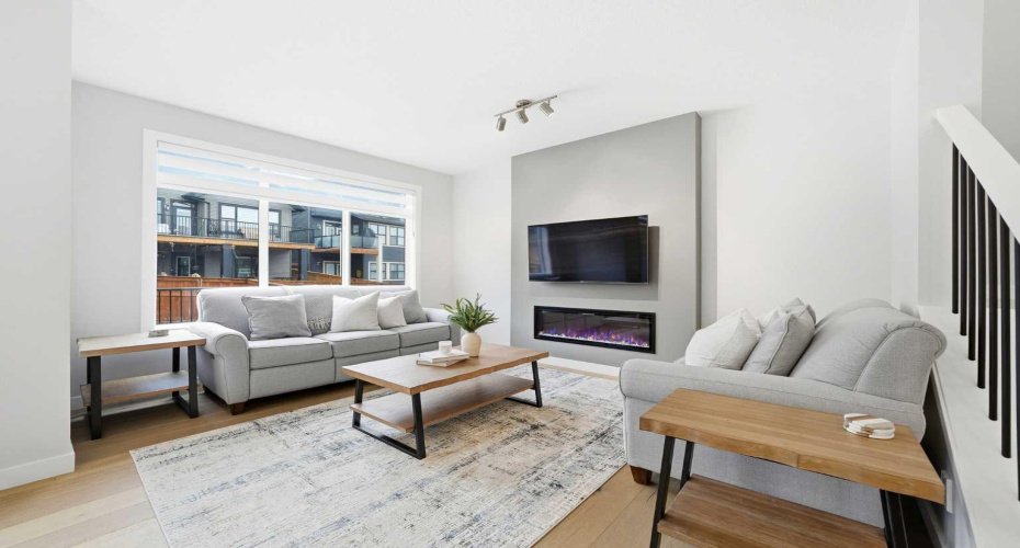 A cozy yet refined living space highlighted by a modern electric fireplace.