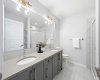 A well-designed primary ensuite with dual vanities and granite countertops.