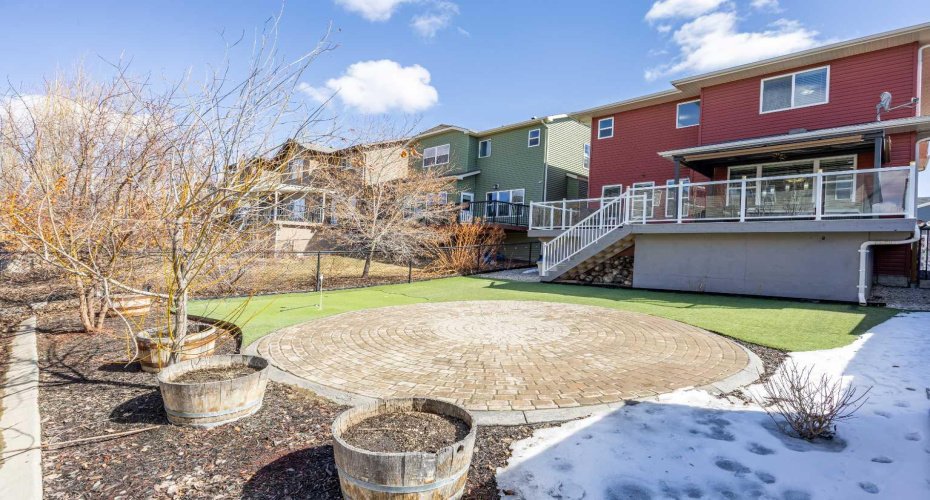 Full-width oversized deck with purgola and turf grass