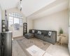 The bonus room stands out with its vaulted ceiling and expansive custom windows...