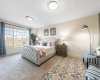 Spacious primary bedroom featuring a cozy seating area—perfect for unwinding with your favorite book...