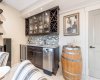Spacious wet bar featuring a sink, bar fridge, and dishwasher, with ample storage for your beverage collection...