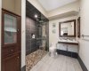 Curbless walk-in shower paired with a sleek floating vanity in the basement...