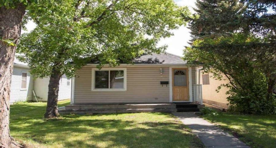 This home is nestled in between beautiful shade providing trees.