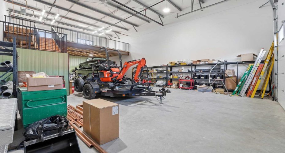 Expansive open floor area ideal for vehicle storage, workshop setups, or business operations.