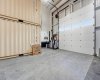 Oversized 18’ x 14’ insulated overhead door with motorized opener and privacy windows