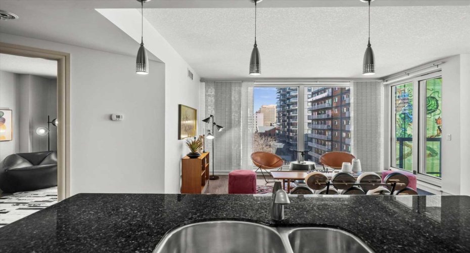 Standing at the kitchen island, you can see straight through to the living room and the windows beyond. The open flow between spaces is one of the things that makes the floor plan work so well day to day.