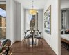 The dining area is tucked just off the main living space with its own window and a warm pendant overhead. It works equally well for a dinner party or a solo meal with a good podcast.