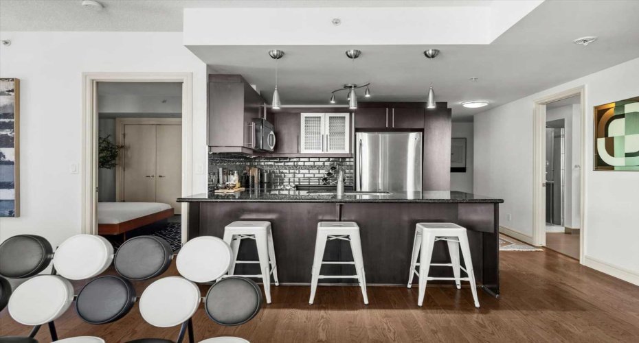 This view from the living room shows just how well the suite is laid out. Bedrooms branch off to either side while the kitchen, dining, and living areas stay open in the middle.