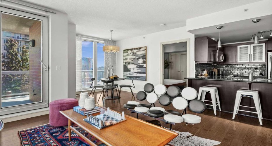 The living and dining areas flow into each other naturally, which makes the suite feel easy to live in whether you are working from home, hosting people, or just unwinding at the end of a long day downtown.