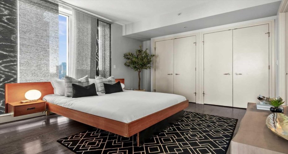 The primary bedroom is quiet, well-proportioned, and separate from the rest of the suite. Hardwood floors, and direct ensuite access make mornings genuinely straightforward.