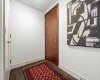 The entry foyer sets a calm, collected tone before you reach the main living areas. There is room to land when you get home, with a proper front door and hardwood floors carrying through from the moment you walk in.