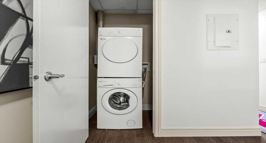 In-suite stacked washer and dryer, tucked away in their own closet just off the entry. It is one of those things you do not think about until you are living somewhere that does not have it.