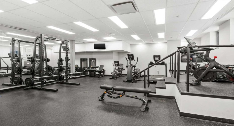 A second angle of the fitness centre shows the full weight rack, Smith machine, and Peloton bike. For a building amenity, it is genuinely well equipped and reflects the level of care that goes into maintaining The Montana.