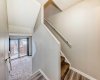 Staircase to kitchen with view of living room