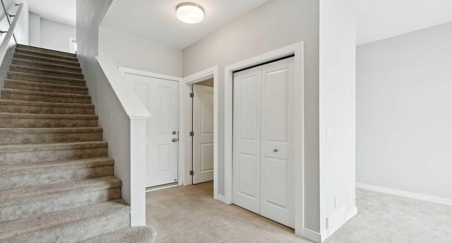 Entry from garage with flex room and half bath