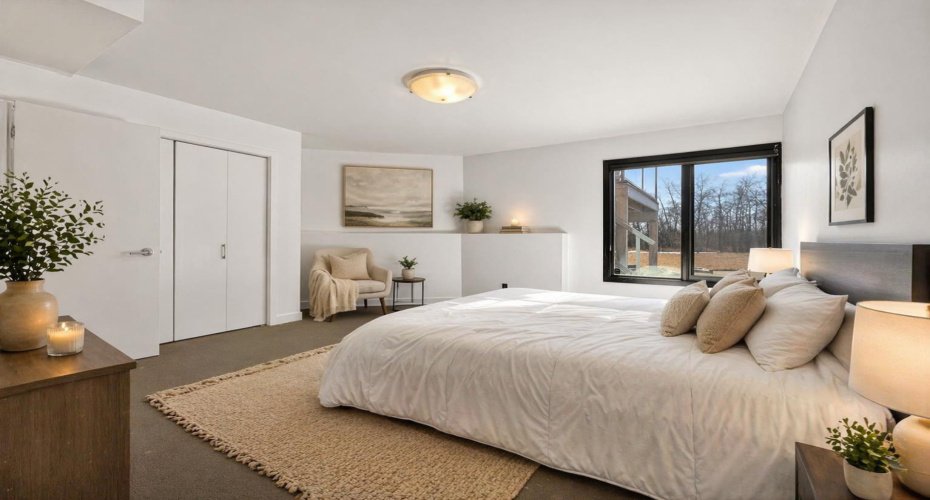 Lower level guest suite. This image has been digitally staged/altered.