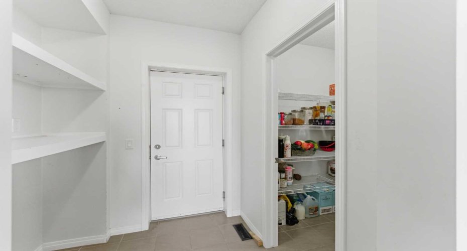 The kitchen features granite countertops, a large pantry, a central island, and ample cabinetry and space