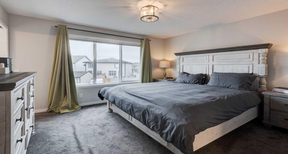 Primary bedroom easily accommodates king size furniture