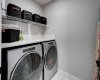 Upstairs laundry room with quartz counter and storage shelving
