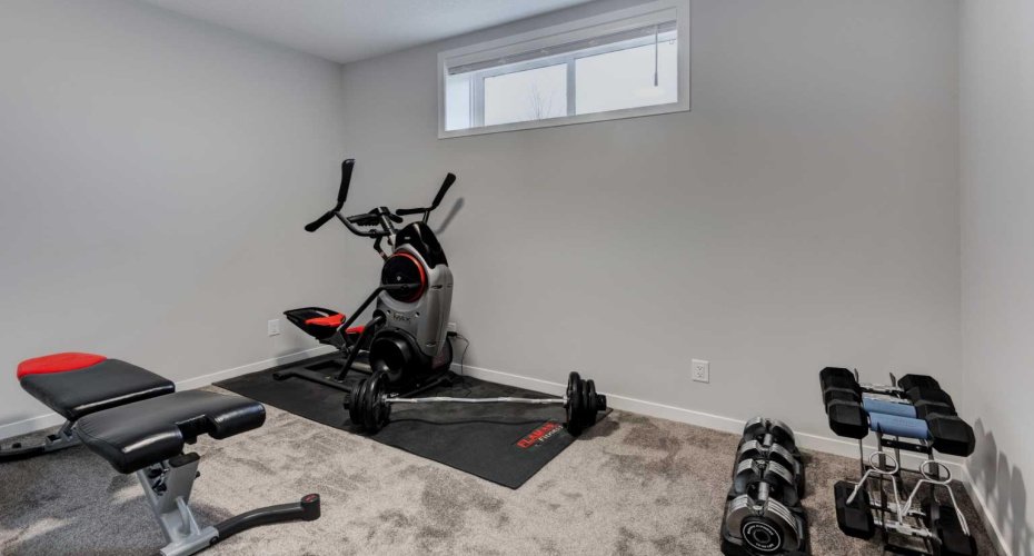 Basement bedroom that currently is being used for a gym