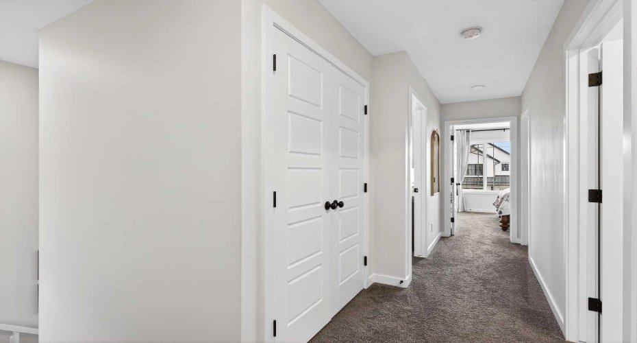 double door hall closet with wood shelves