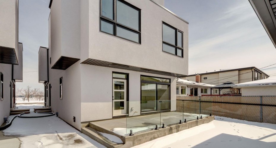 Large Back Deck with Contemporary Glass Railings. Fence to be installed in the Spring