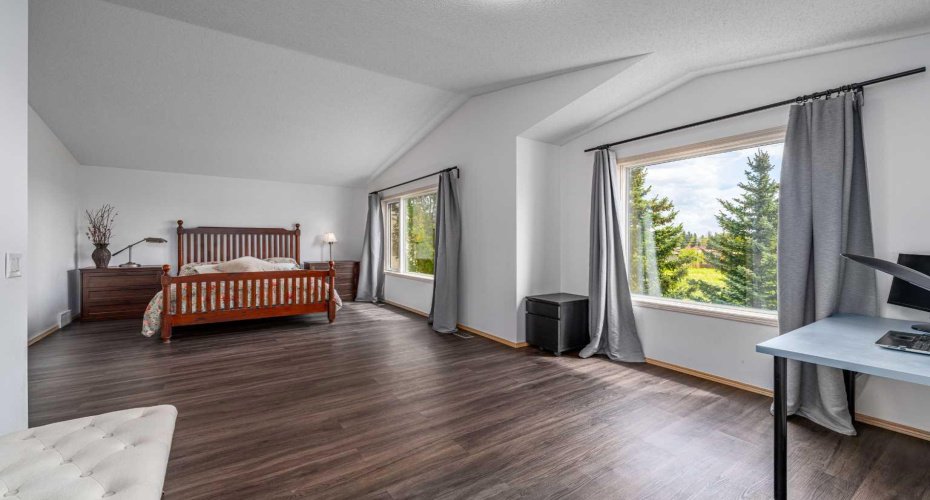 Huge primary suite, with tall vaulted ceilings and tons of natural light