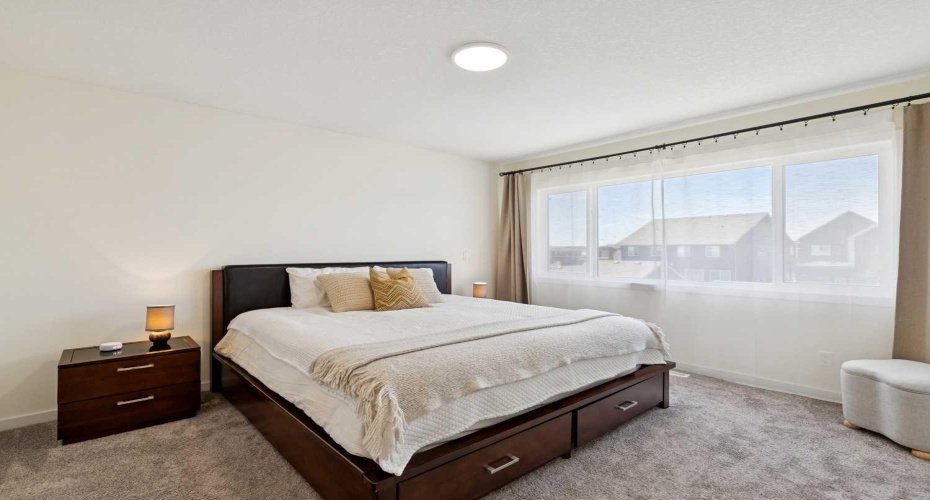 Your expansive primary bedroom serves as a peaceful retreat, complete with a luxurious 3-piece en suite bathroom. It’s the perfect spot to unwind after a long day or start your morning in serenity.